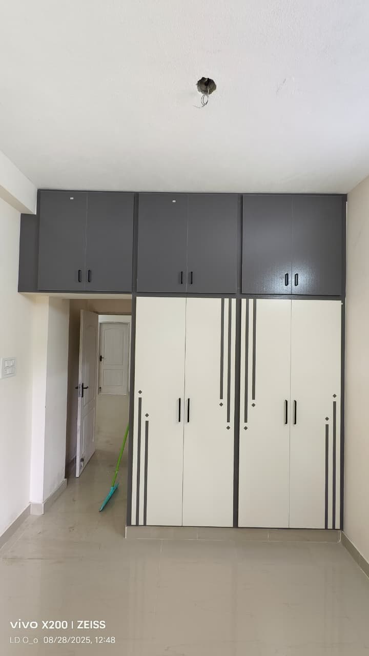 Floor-to-ceiling UPVC wardrobe with grey stripe pattern and loft storage